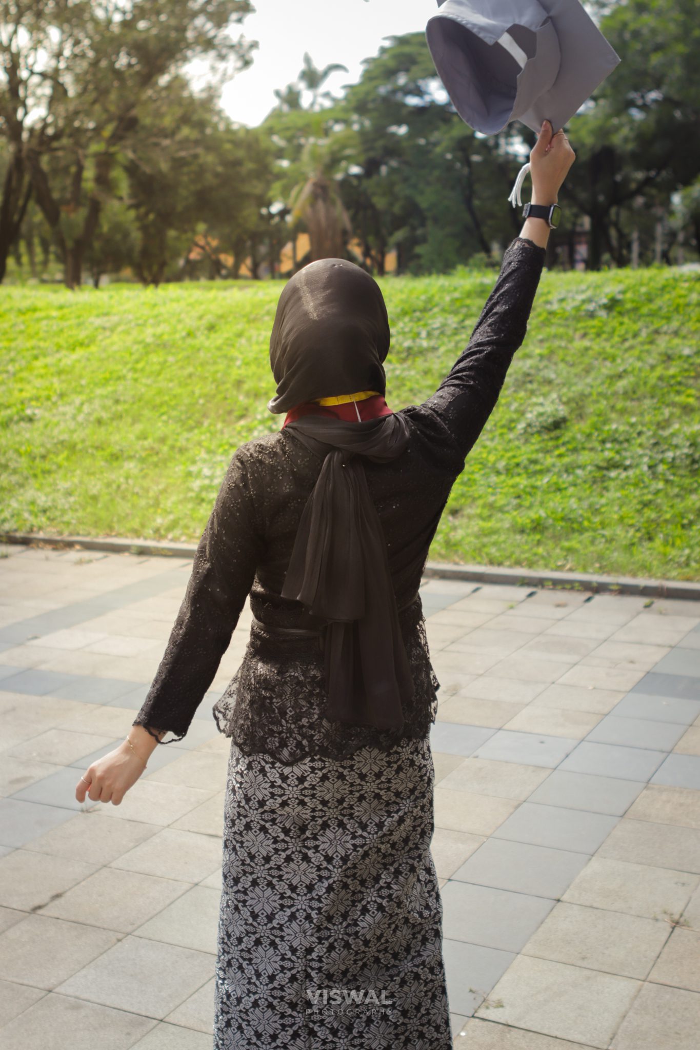 Sesi candid wisuda di halaman kampus